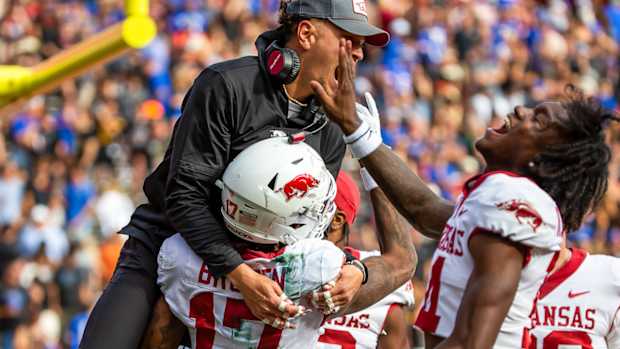 Razorbacks Tyrone Broden (17) teammates and staffers celebrate win in overtime over Florida